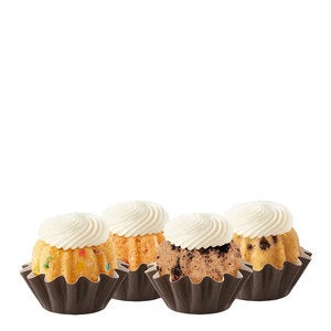 Four Bundtinis sitting in a row. Confetti,Oreo Cookies & Cream, Strawberries & Cream, and seasonal flavor.